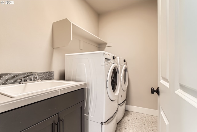 clothes washing area with cabinets, separate washer and dryer, and sink