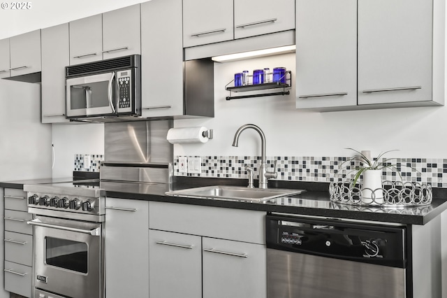 12600 SW Crescent St, Beaverton, OR 97005 - kitchen featuring appliances with stainless steel finishes, dark countertops, a sink, and tasteful backsplash