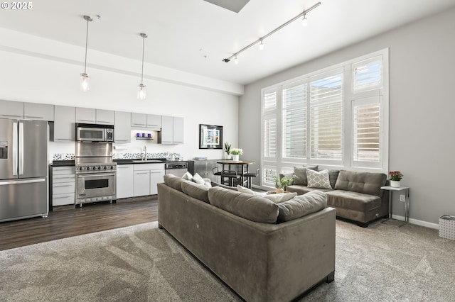 12600 SW Crescent St, Beaverton, OR 97005 - living area featuring dark colored carpet, track lighting, and baseboards