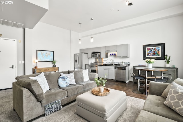 12600 SW Crescent St, Beaverton, OR 97005 - living area featuring dark wood-type flooring, a towering ceiling, and baseboards