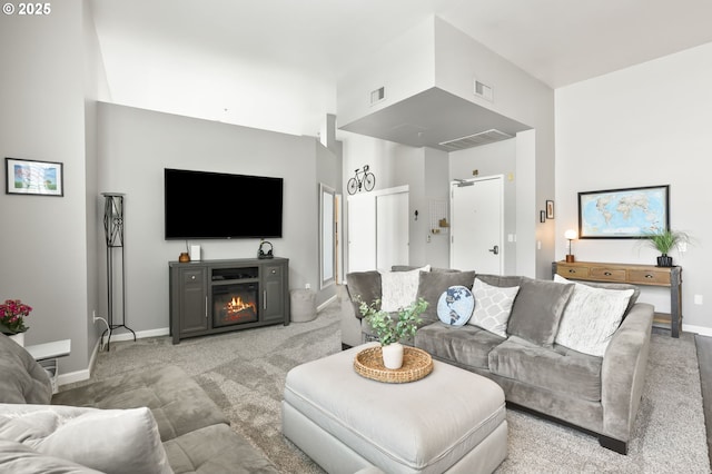 12600 SW Crescent St, Beaverton, OR 97005 - living room featuring carpet floors, baseboards, and a glass covered fireplace