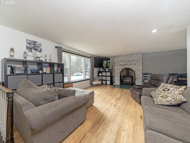 living area with a textured ceiling and wood finished floors