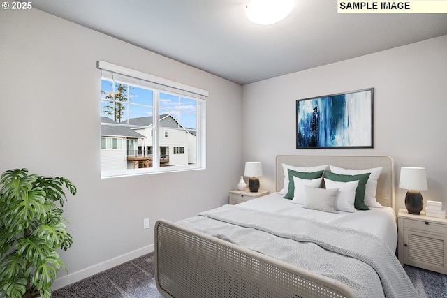 bedroom featuring carpet floors and baseboards