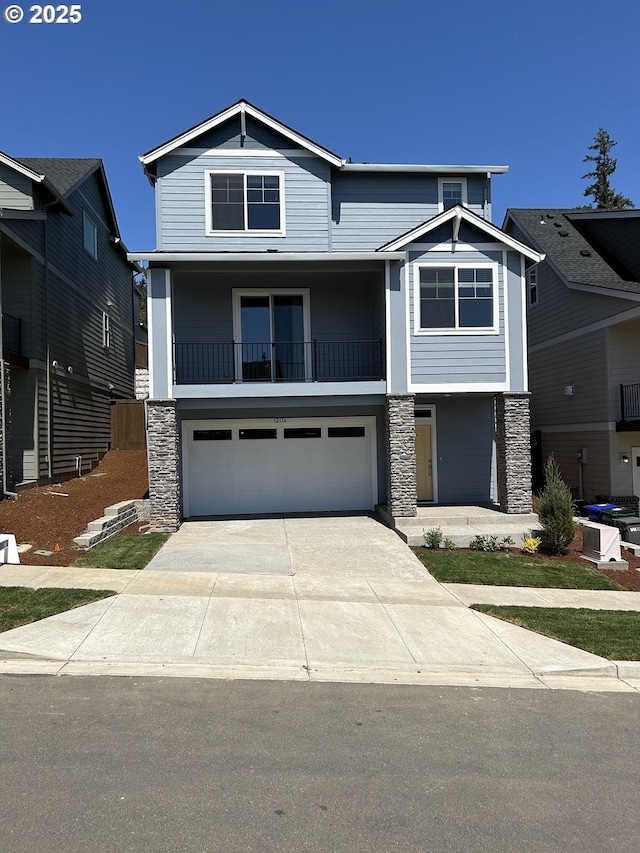 12176 SW Champlin Ln, Beaverton, OR 97007 - view of front of house featuring stone siding, concrete driveway, a garage, and a balcony