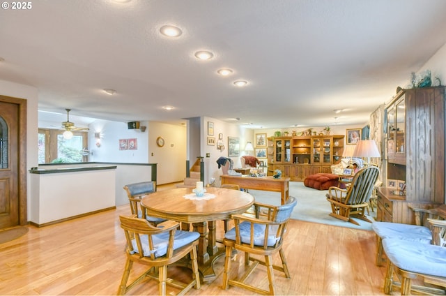 dining space featuring ceiling fan and light wood-type flooring