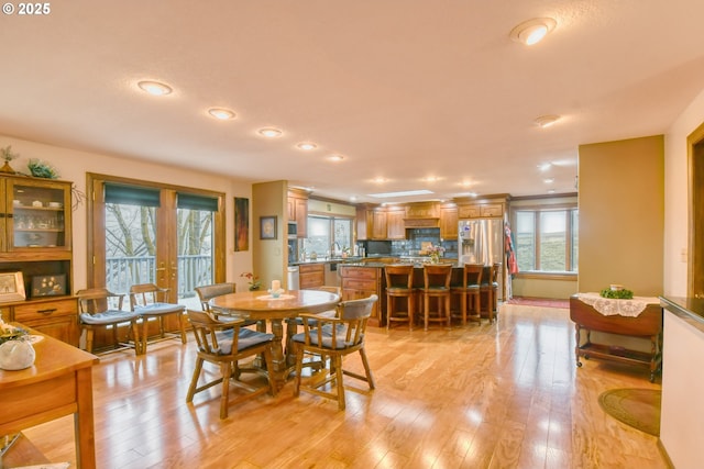 dining room with sink and light wood-type flooring