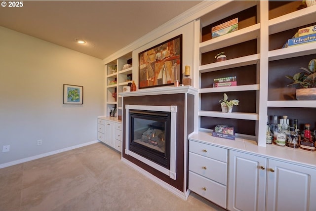 living room with built in features and light colored carpet