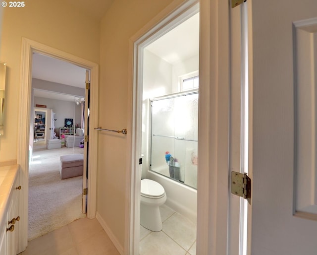 full bathroom with toilet, combined bath / shower with glass door, tile patterned flooring, and vanity