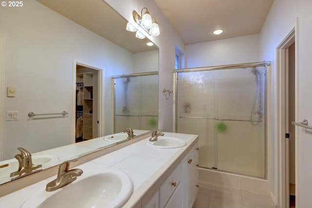 bathroom with walk in shower, vanity, and tile patterned floors