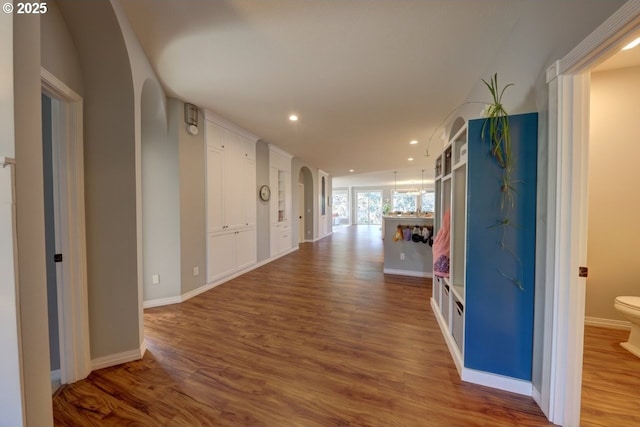 hall with hardwood / wood-style flooring