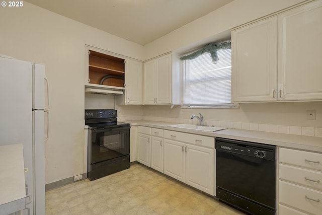 kitchen with white cabinetry, sink, and black appliances