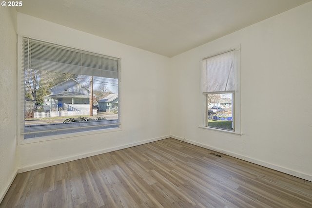 empty room with hardwood / wood-style floors