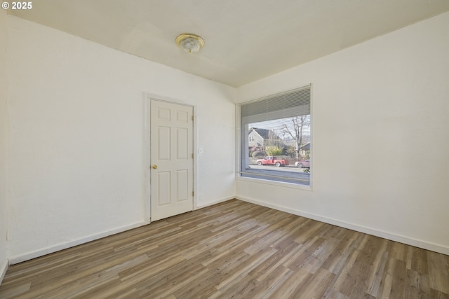 unfurnished room with hardwood / wood-style floors