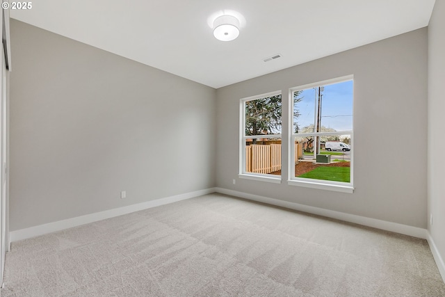 5477 SE Golden Rd, Hillsboro, OR 97123 - unfurnished room featuring baseboards and light carpet