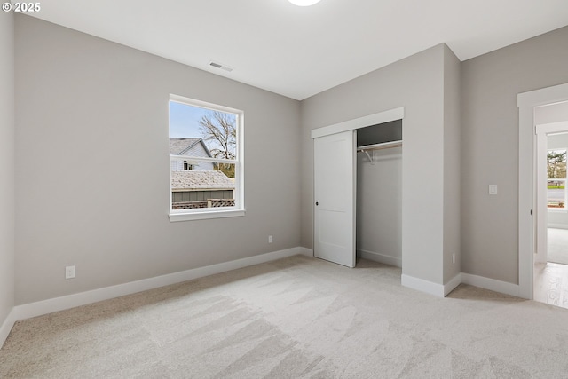 5477 SE Golden Rd, Hillsboro, OR 97123 - unfurnished bedroom featuring carpet floors, multiple windows, and baseboards