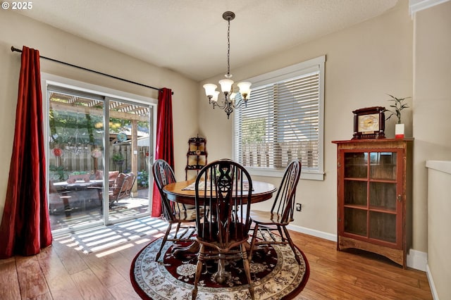 12626 Tradewind St, Oregon City, OR 97045 - dining space with a chandelier, hardwood / wood-style flooring, and baseboards