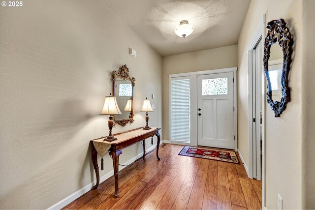 12626 Tradewind St, Oregon City, OR 97045 - foyer entrance with hardwood / wood-style floors, baseboards, and a textured ceiling