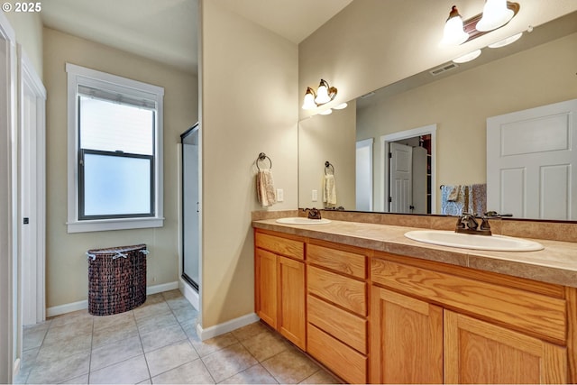 12626 Tradewind St, Oregon City, OR 97045 - full bathroom featuring double vanity, a shower stall, tile patterned flooring, and baseboards
