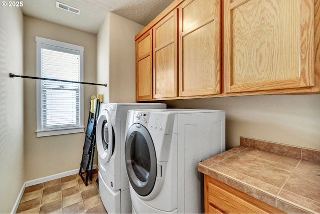 12626 Tradewind St, Oregon City, OR 97045 - laundry room with cabinet space, separate washer and dryer, and baseboards