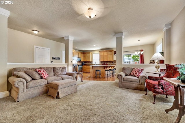 12626 Tradewind St, Oregon City, OR 97045 - living room with light carpet, a textured ceiling, a chandelier, decorative columns, and recessed lighting