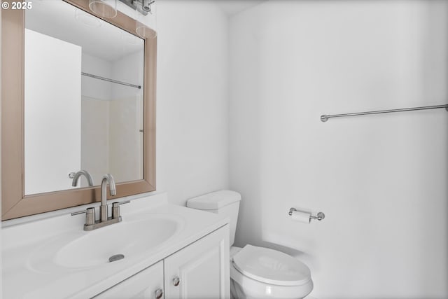 bathroom with vanity, toilet, and walk in shower