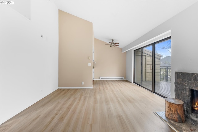 unfurnished living room featuring light wood-type flooring, vaulted ceiling, baseboard heating, ceiling fan, and a fireplace