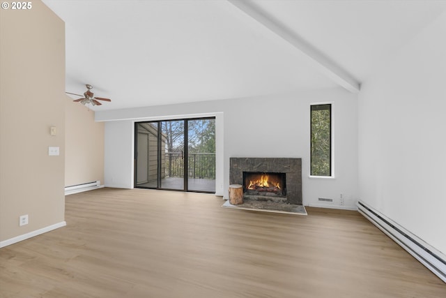 unfurnished living room featuring light wood-type flooring, ceiling fan, beam ceiling, a baseboard radiator, and a premium fireplace