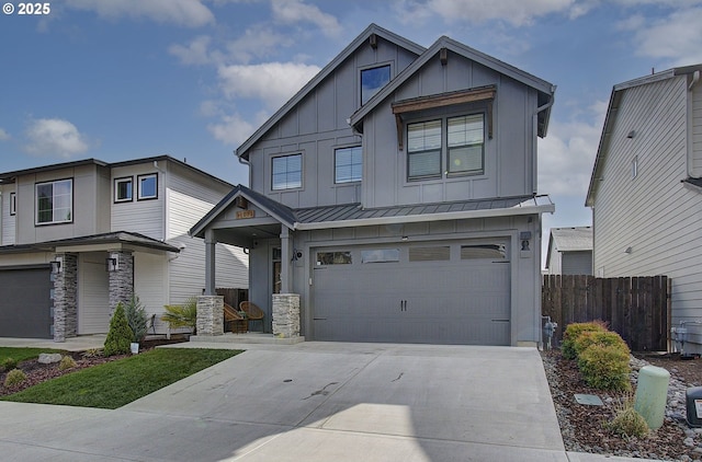 craftsman inspired home featuring a standing seam roof, driveway, fence, a garage, and board and batten siding