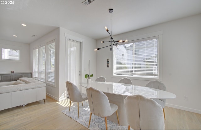 dining space with baseboards, a notable chandelier, light wood-style floors, and recessed lighting