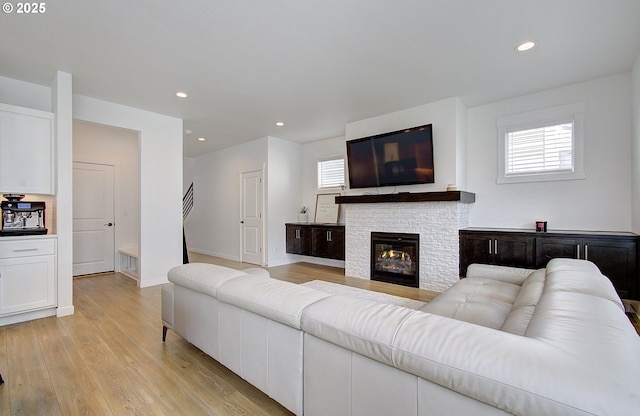 living room with light wood finished floors, plenty of natural light, baseboards, and recessed lighting
