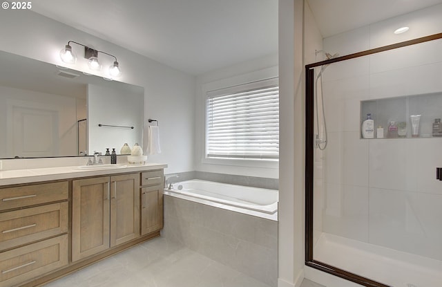 bathroom with a shower stall, a garden tub, tile patterned floors, vanity, and visible vents