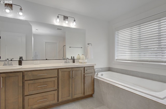 full bath featuring a bath, a sink, and double vanity