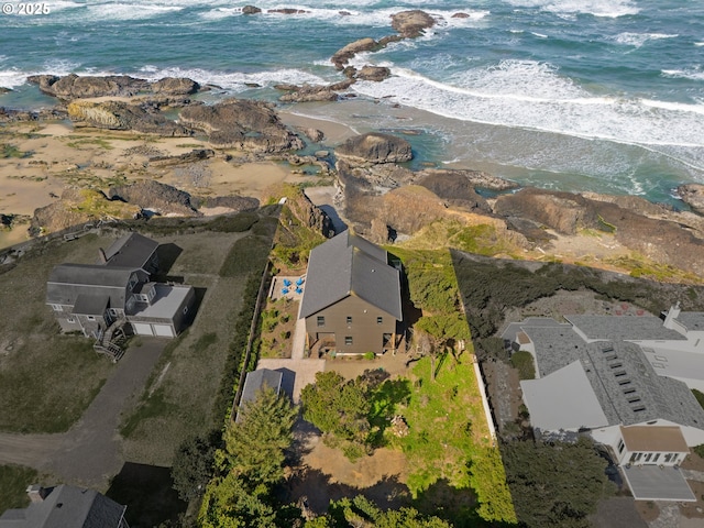 drone / aerial view featuring a beach view and a water view