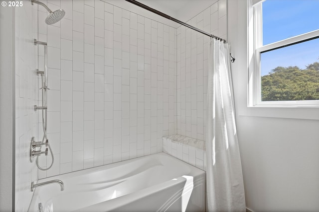bathroom with a healthy amount of sunlight and shower / bath combo