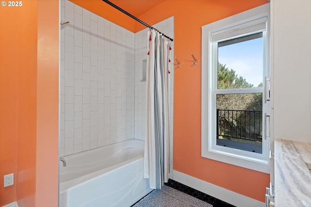 bathroom with shower / bath combination with curtain and baseboards