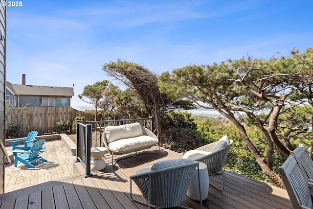 wooden terrace with fence and a patio area