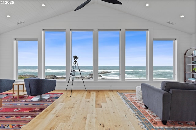 8466 NW Coast Rd, Seal Rock, OR 97376 - living area with vaulted ceiling, hardwood / wood-style flooring, a water view, a ceiling fan, and recessed lighting