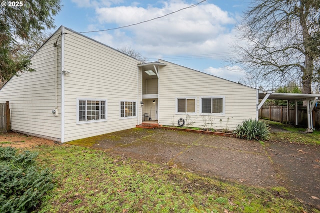 back of house with a carport