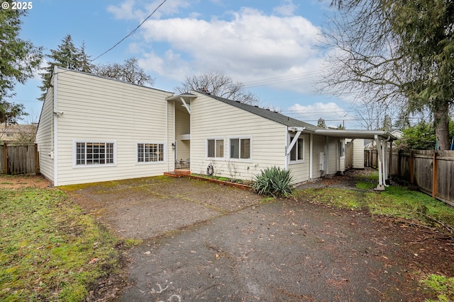 rear view of property with a carport