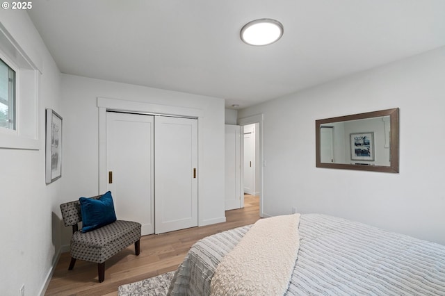 bedroom featuring a closet and light wood-type flooring