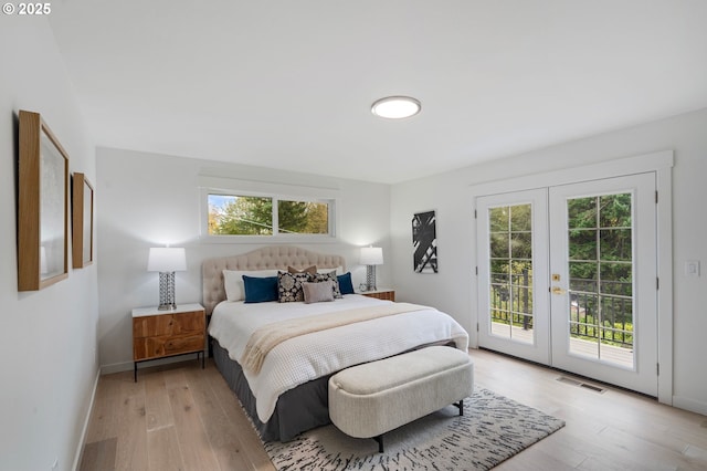 bedroom with french doors, light hardwood / wood-style flooring, and access to outside