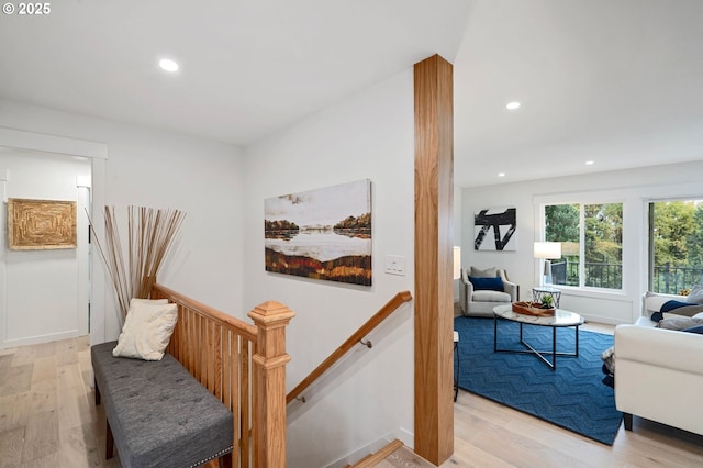 hallway with light hardwood / wood-style floors