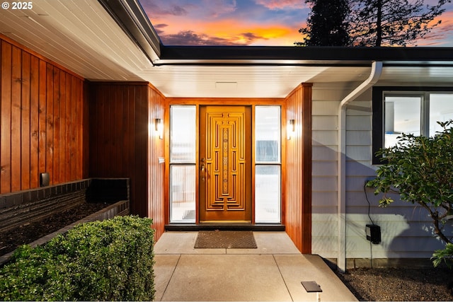 view of exterior entry at dusk