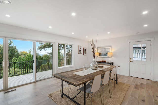 dining space with light wood-type flooring