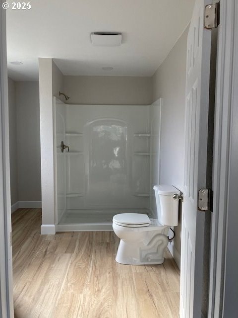 100 NW 7th Ave, John Day, OR 97845 - full bath with wood finished floors, walk in shower, toilet, and baseboards