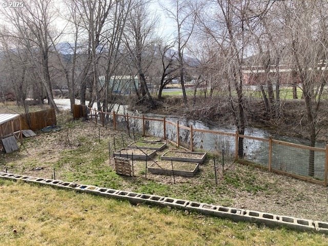 100 NW 7th Ave, John Day, OR 97845 - view of yard featuring a vegetable garden and a water view