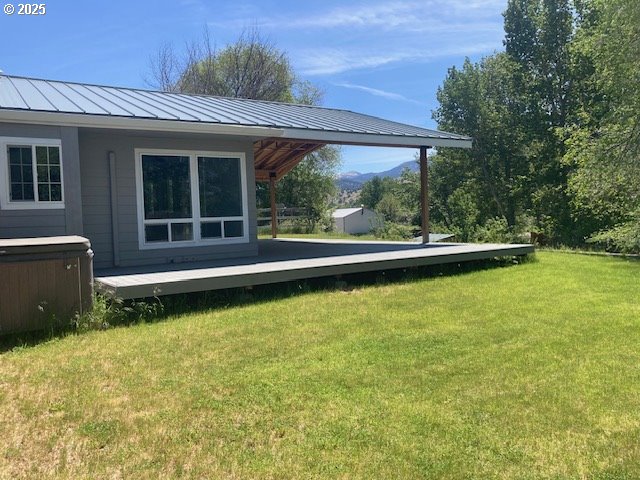 100 NW 7th Ave, John Day, OR 97845 - view of grassy yard with a wooden deck and a hot tub