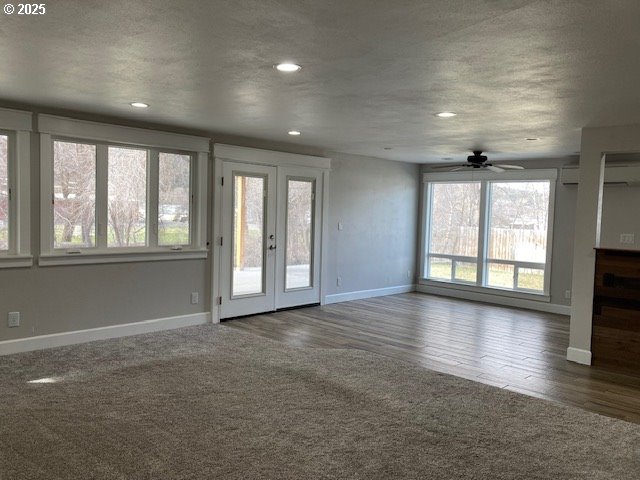 100 NW 7th Ave, John Day, OR 97845 - unfurnished living room featuring baseboards, ceiling fan, french doors, recessed lighting, and wood finished floors