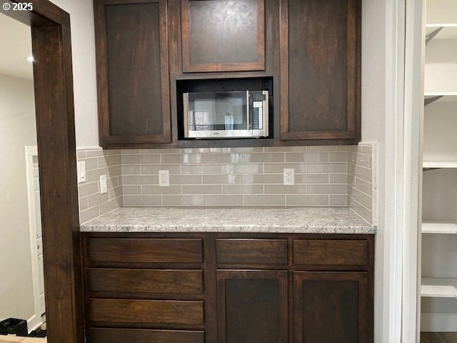 100 NW 7th Ave, John Day, OR 97845 - kitchen featuring stainless steel microwave, dark brown cabinets, and light countertops
