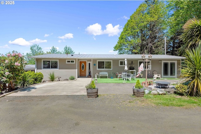 63642 Flanagan Rd, Coos Bay, OR 97420 - view of front of home with a standing seam roof, metal roof, and a patio